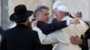 FILE - Pope Francis embraces two good friends traveling with him, Argentine Rabbi Abraham Skorka, center, and Omar Abboud, leader of Argentina's Muslim community, partially seen next to the Pope, after praying at the Western Wall in Jerusalem's Old City, Israel, May 26, 2014.