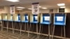 FILE - Voting booths stand ready in downtown Minneapolis for the opening of early voting in Minnesota, Sept. 20, 2018, in U.S. midterm elections. 