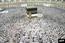 Muslim worshippers perform prayers around the Kaaba, Islam's holiest shrine, at the Grand Mosque in Saudi Arabia's holy city of Mecca, Aug. 15, 2018, before the start of the annual Hajj pilgrimage in the holy city.