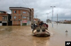 Military vehicles rescue people after flash flooding around the northern city of Aq Qala in Golestan province, Iran, March 25, 2019.