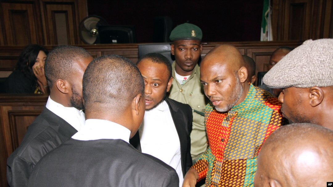 FILE - Biafran separatist leader Nnamdi Kanu, center right, speaks to his lawyers at the Federal High court in Abuja, Nigeria, Jan. 29, 2016. Kanu's current whereabouts are unknown.