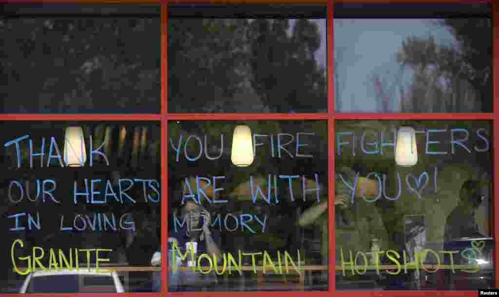 A tribute message for firefighters is displayed on the windows of a coffee shop in Prescott, Arizona, July 1, 2013.