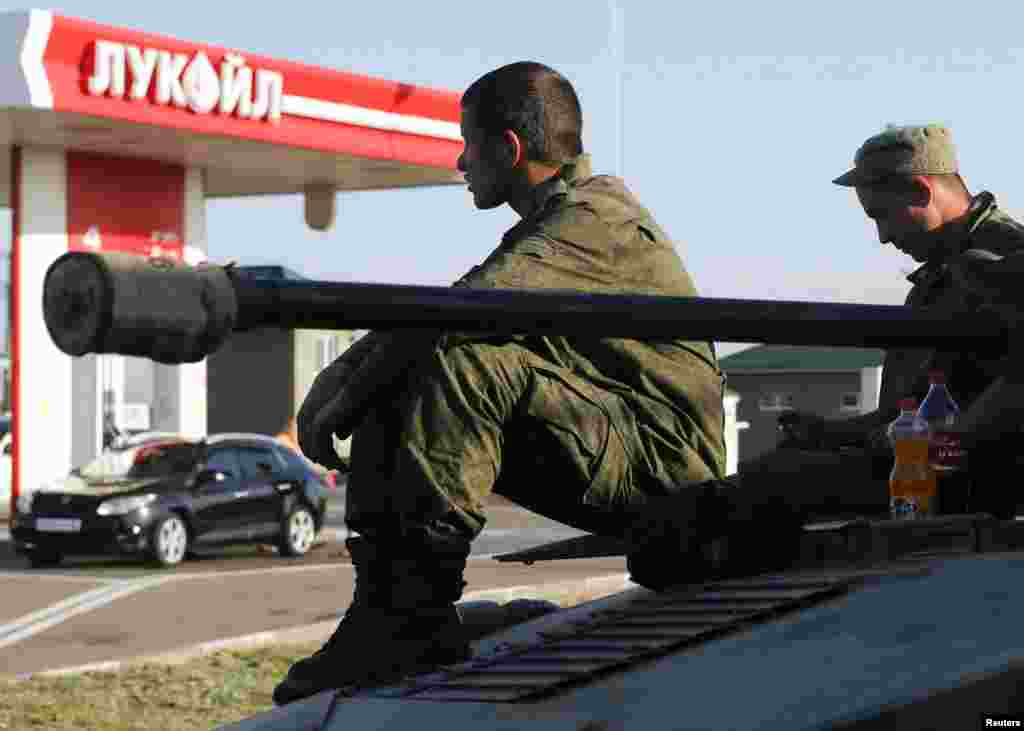 Dozens of heavy Russian military vehicles amassed near the border with Ukraine where a huge Russian convoy with humanitarian aid came to a halt as Moscow and Kiev struggled to agree on border crossing procedures, Aug. 15, 2014.