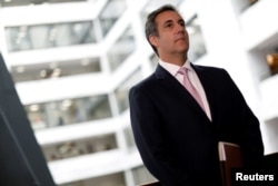 FILE - Michael Cohen, President Donald Trump's personal attorney, looks on as his attorney (not pictured) delivers a statement to reporters after meeting with Senate Intelligence Committee staff on Capitol Hill in Washington, Sept. 19, 2017.