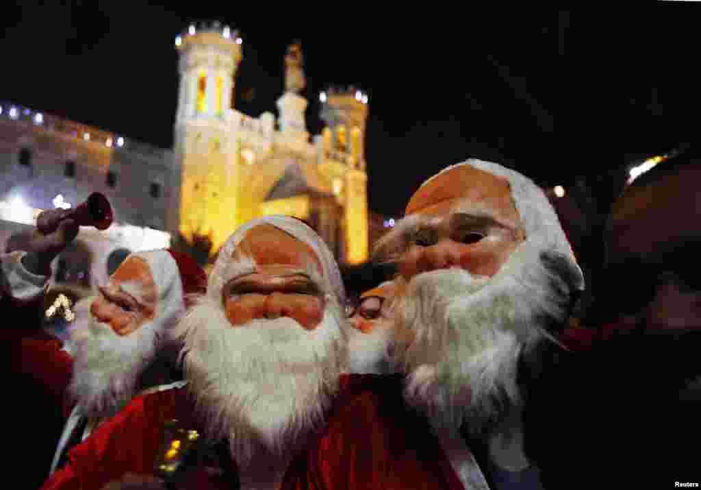 Palestinians dressed up as Santa Claus take part in a parade ahead of Christmas near Jerusalem's Old City December 16.
