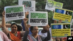 Pakistani human rights activists rally against disappearances of people on the International Day of the Victims of Enforced Disappearance in Lahore, Pakistan, Aug. 30, 2016.
