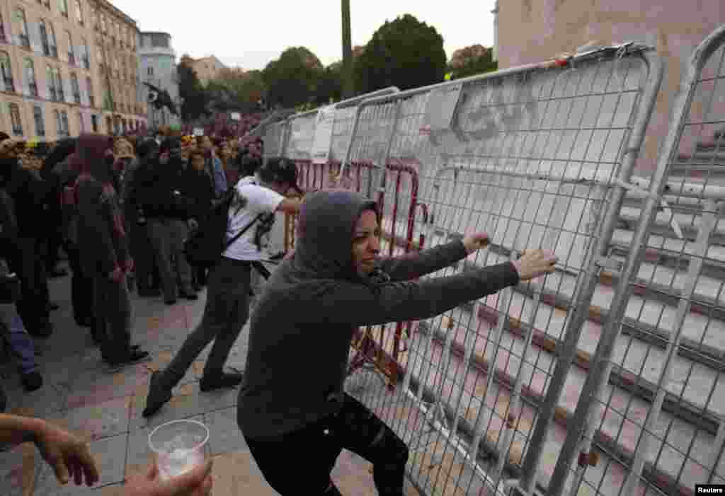 Manifestantes derrubam barreira policial em frente ao Parlamento em Lisboa