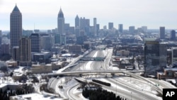 s creating massive traffic jams lasting through Wednesday, Jan. 29, 2014, in Atlanta.