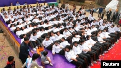 资料照：中国南京一群学生在一个家具展上在一个垫子上躺下。
