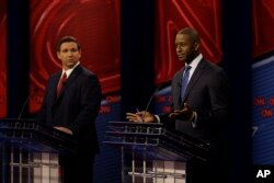 Republican gubernatorial candidate Ron DeSantis, left and Democratic gubernatorial candidate Andrew Gillum are shown during a debate, Oct. 21, 2018, in Tampa, Florida.