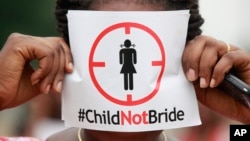 A woman protests underage marriages in Lagos, Nigeria, July 20, 2013. Underage marriage is a problem around the world. Activists are calling on former Soviet countries to overhaul laws against sexual violence and child marriage.