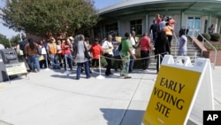 FILE - Voters line up during early voting at Chavis Community Center in Raleigh, N.C., Oct. 20, 2016. Voters in the key presidential battleground of North Carolina demonstrated keen interest on the first day of early voting, as some waited in line for more than an hour Thursday to cast ballots. 