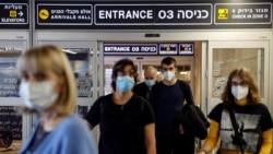 Travelers exit Ben Gurion International Airport as Israel imposes new coronavirus disease restrictions near Tel Aviv, Israel, Nov. 28, 2021.