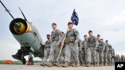 U.S. paratroopers after being flown into the air base in Swidwin, Poland for weeks of joint military exercises, April 23, 2014.