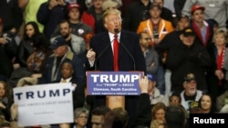 Republican U.S. presidential candidate Donald Trump takes the stage for a rally at Clemson University's arena in Pendleton, South Carolina Feb. 10, 2016.