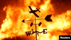 FILE - A weather vane is pictured on a ranch during the Creek Fire in the San Fernando Valley north of Los Angeles, in Sylmar, California, Dec. 5, 2017.