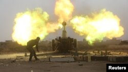 Popular Mobilization Forces (PMF) fire towards Islamic State militants during a battle on the outskirts of Al-Ba'aj, west of Mosul, May 26, 2017. 