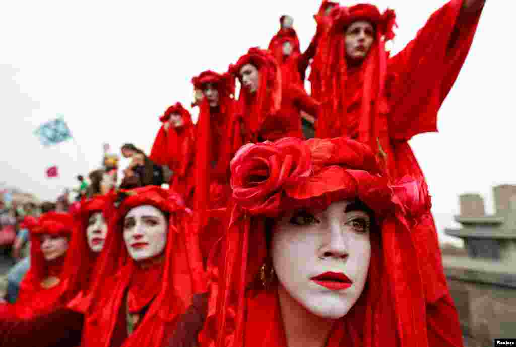 Performers demonstrate at Waterloo Bridge during the Extinction Rebellion protest in London, Britain.