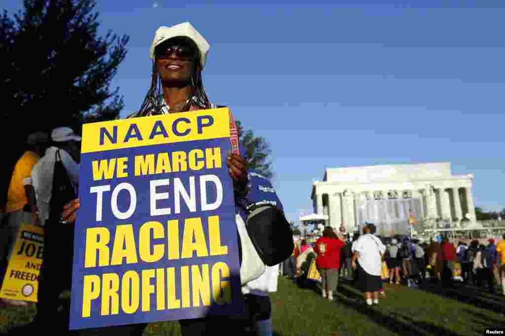 A marcher holds a sign as she attends the 50th anniversary of the 1963 March on Washington for Jobs and Freedom at the Lincoln Memorial in Washington, Aug. 24, 2013. 