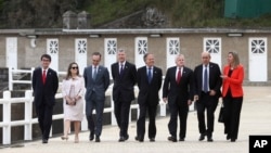 Participants of a G-7 ministerial meeting walk to have a group photo taken on the second day of their talks, in Dinard, France, April 6, 2019.