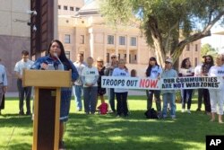 Amy Juan, a citizen of the Tohono O'odham Nation in Arizona, speaks out against the military's presence at the U.S.-Mexico border in Phoenix, Nov. 8, 2018.