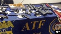 Des Weapons seized after hundreds of law enforcement officers raided homes on the east side of Los Angeles, searching for Big Hazard gang members with ties to the Mexican Mafia who have been indicted on federal racketeering charges, are on display at a... 