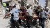 FILE - In this photo, provided by the Syrian Civil Defense White Helmets, rescue workers work the site of airstrikes in the al-Sakhour neighborhood of the rebel-held part of eastern Aleppo, Syria, Sept. 21, 2016. Violence in Aleppo has surged in recent days as a U.S.-Russia-brokered cease-fire collapsed after one week.