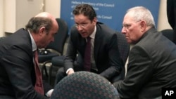 Eurogroup President Jeroen Dijsselbloem, center, chats with Luis de Guindos Jurado, Minister of the Economy and Finance of Spain, left, and German Finance Minister Wolfgang Schaeuble, Zappeion Hall, Athens, April 1, 2014.