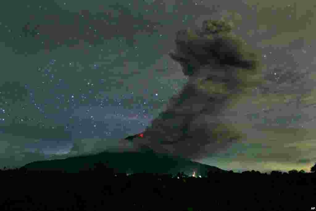 Mount Sinabung spews volcanic ash into the air as seen from Tiga Pancur, North Sumatra, Indonesia, Nov. 24, 2013.