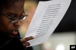 Gabrielle Caldwell, who is partially deaf and blind, looks over her notes before speaking to the Texas school board on history curriculum, Nov. 13, 2018, in Austin, Texas.