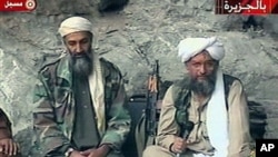 Osama bin Laden, left, and his top lieutenant, Egyptian Ayman al-Zawahri, right, are seen at an undisclosed location in this TV image broadcast, October 2001 (file photo)