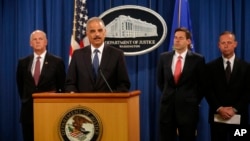 FILE: U.S. officials announced charges against five Chinese military officers at a Washington, D.C., news conference May 19, 2014. Attorney General Eric Holder, second from left, is joined by, from left, David Hickton, John Carlin and Robert Anderson.