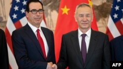 China's Vice Premier Liu He, right, shakes hands with U.S. Treasury Secretary Steven Mnuchin as they pose for a photo at the Diaoyutai State Guesthouse in Beijing, March 29, 2019.