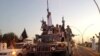 FILE - Islamic State militants flaunt an armored vehicle seized from Iraqi security forces in the northern Iraq city of Mosul on June 23, 2014.