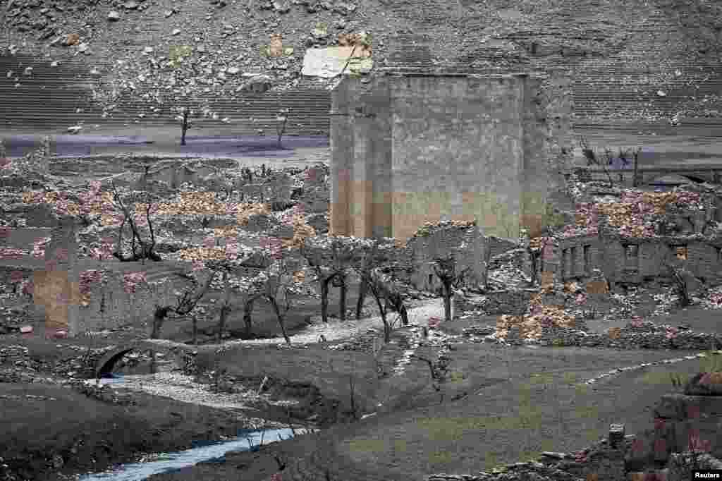 The ruins of the old town of Mansilla de la Sierra, normally submerged beneath the waters of the Mansilla reservoir, are revealed following a prolonged drought, in Rioja province, Spain, August 28, 2017. 