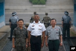 Commander of the United Nations Command, Combined Forces Command, and United States Forces Korea General Vincent K. Brooks , center, poses for photographs with South Korean military officials during a ceremony marking the 63rd anniversary of the signing of the Korean War ceasefire armistice agreement at the truce village of Panmunjom, South Korea on July 27, 2016.
