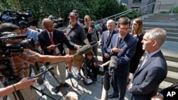 Washington state Attorney General Bob Ferguson, third right, speaks with reporters following a hearing at which a federal judge issued a temporary restraining order to stop the release of blueprints to make untraceable and undetectable 3-D-printed plastic guns, July 31, 2018. 