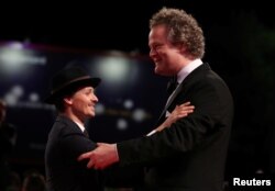 FILE - Director Florian Henckel von Donnersmarck, right, and actor Tom Schilling are pictured during the red carpet arrivals for the screening of "Werk Ohne Autor" ("Never Look Away") at the Venice Film Festival, Sept. 4, 2018.