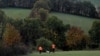 FILE - Hunters walk with a dog in Montamel, southwestern France, Nov. 7, 2021. Some people are accusing EU officials of introducing bears to the wild without considering the impact on local communities.