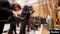 Media films the stove at the Sistine Chapel in the Vatican, March 9, 2013.