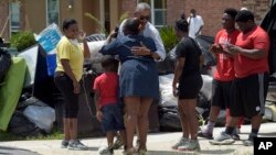 President Barack Obama greets residents as he tours Castle Place, a flood-damaged area of Baton Rouge, La., Aug. 23, 2016. 