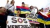 Demonstrators who are against the Venezuelan government chant outside of the Organization of American States (OAS) during the special meeting of the Permanent Council, in Washington, April 3, 2017, to consider the recent events in Venezuela.