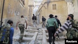 Members of the Free Syrian Army climb up stairs during a patrol in Haram town in Idlib Governorate, October 30, 2012. 