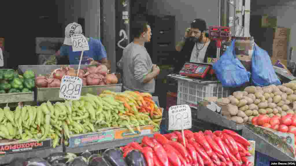 Hassan Mansour goes shopping in Athens’ central market. A Syrian refugee, Hassan is a volunteer at the Khora center and takes on the role of head chef, in the Exarchia district in Athens, Greece, Oct. 24, 2016.