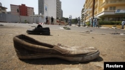 Abandoned shoes litter a street in Plateau district where a stampede occurred after a New Year's Eve fireworks display, Abidjan, Jan. 1, 2013.