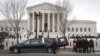The body of Justice Antonin Scalia arrives at the Supreme Court in Washington, Feb. 19, 2016. Thousands of mourners will pay their respects to him Friday in the court building's Great Hall.