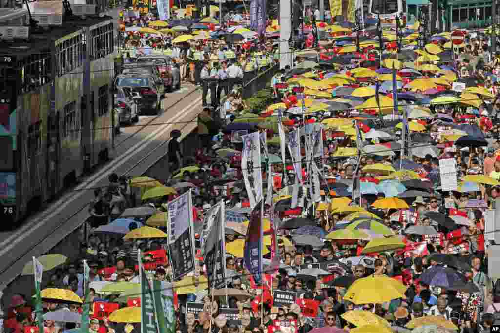 Thousands of protesters march along a downtown street against the extradition law in Hong Kong.