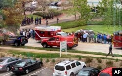 Police officers and students are seen outside STEM School Highlands Ranch, a charter middle school in the Denver suburb of Highlands Ranch, Colo., after a shooting May 7, 2019.