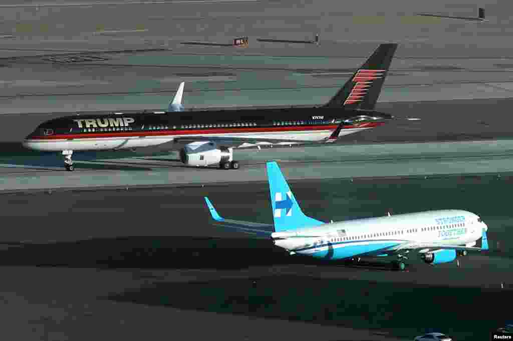 U.S. Republican presidential nominee Donald Trump's campaign plane passes U.S. Democratic presidential nominee Hillary Clinton's campaign plane as it lands in Las Vegas.