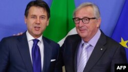 President of the European Commission, Jean Claude Juncker, right, receives Italian Prime Minister, Giuseppe Conte at the European Commission headquarters, Dec. 12, 2018, in Brussels.
